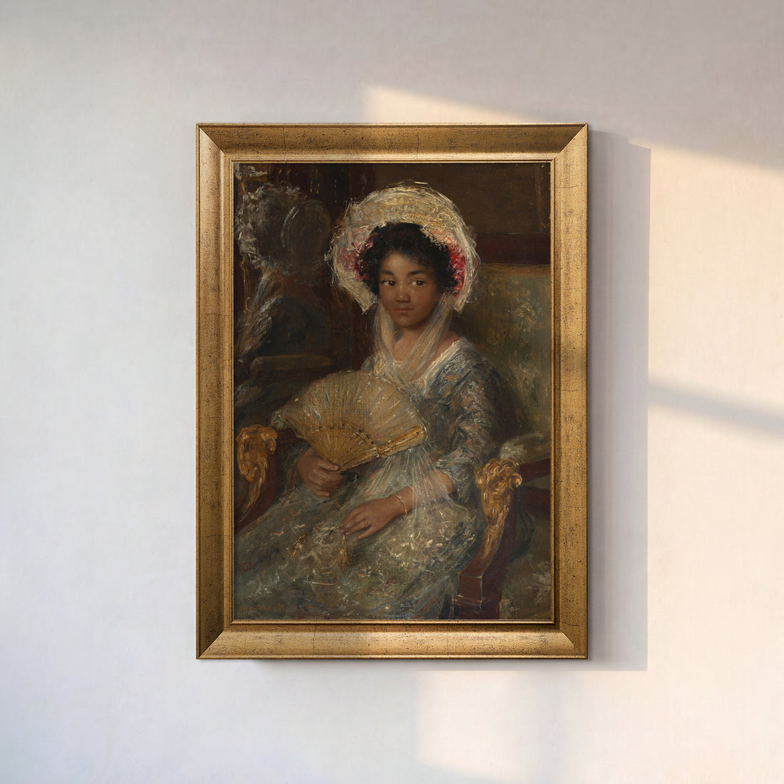 Vintage Woman with Fan canvas print in a gold frame on a sunlit white wall