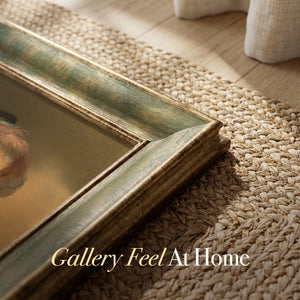 Corner of the olive green frame resting on a woven jute rug